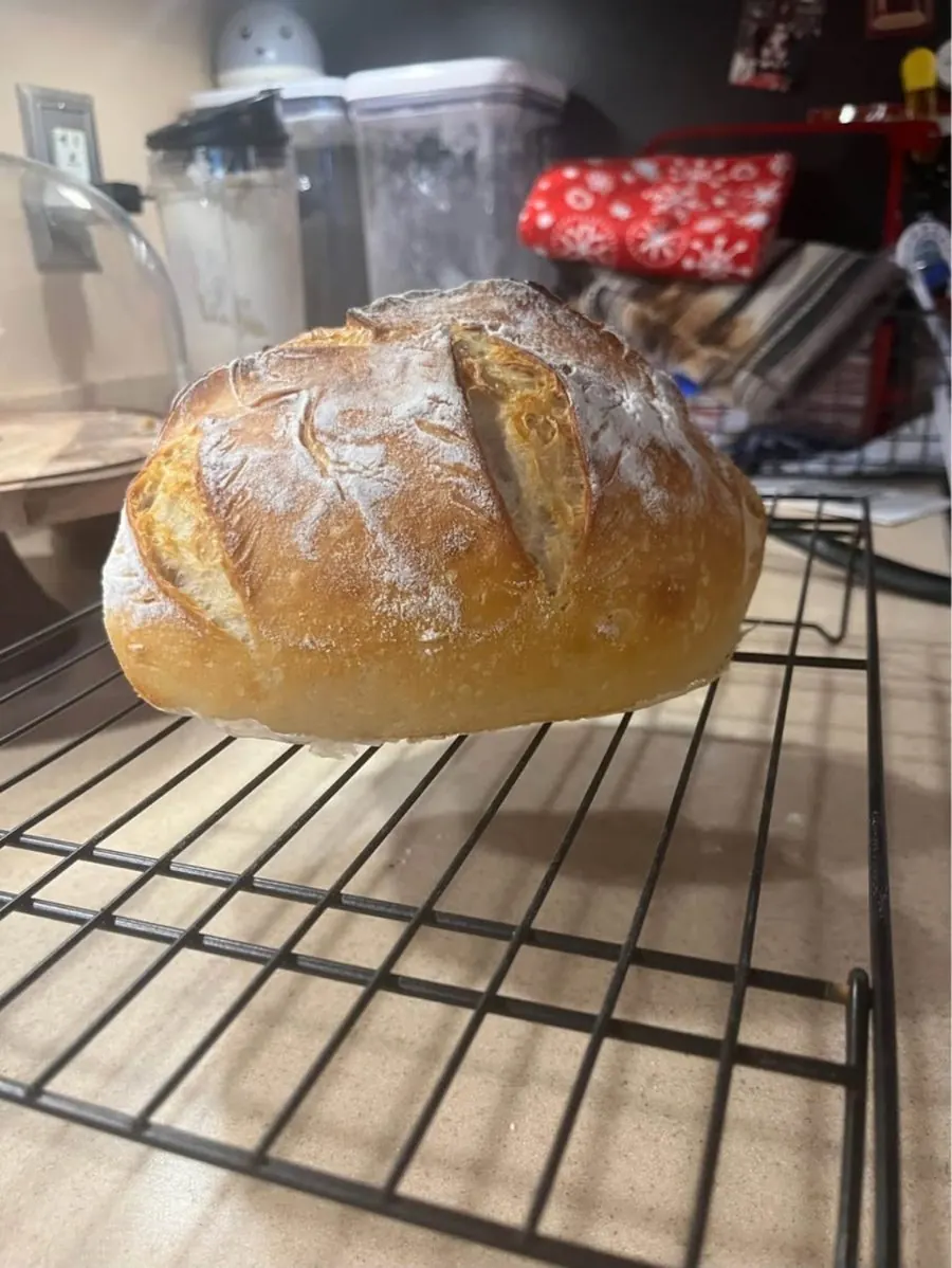 Round sourdough loaf on a cooling rack